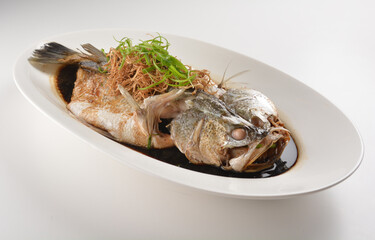 hong kong style steamed whole fresh grouper fish in soya salted sauce and ginger and garlic onion...