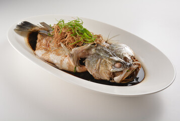 hong kong style steamed whole fresh grouper fish in soya salted sauce and ginger and garlic onion seafood asian menu