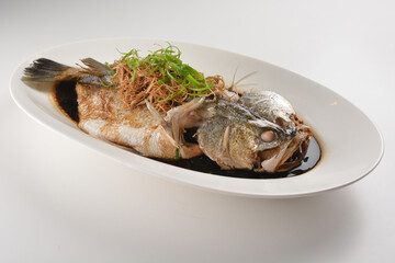 hong kong style steamed whole fresh grouper fish in soya salted sauce and ginger and garlic onion seafood asian menu