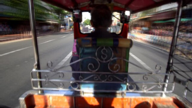 High speed Tuk Tuk driving on street in Bangkok, Thailand. A popular three-wheeled taxi transport in Bangkok.