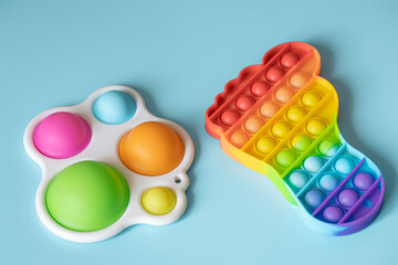 Two silicone colorful anti-stress toys Pop It and Simple Dimple close up.