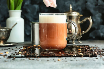 Delicious tea with milk.  Red tea latte.  Decaffeinated drink. Delicate milk froth.