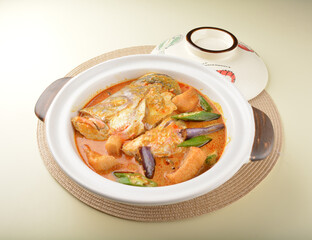 chef cook home style nyonya spicy curry grouper fish head with vegetables in big clay pot asian Chinese banquet halal seafood steamboat cafe restaurant menu