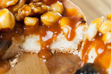 round tartlet with nuts and dried fruits poured with caramel