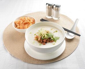 chef boiled Hong Kong teochew congee porridge with peanut, onion and cracker healthy halal vegan menu