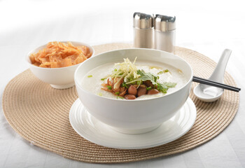 chef boiled Hong Kong teochew congee porridge with peanut, onion and cracker healthy halal vegan menu