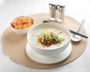 chef boiled Hong Kong teochew congee porridge with peanut, onion and cracker healthy halal vegan menu