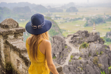 Woman tourist on top pagoda of Hang Mua temple, rice fields, Ninh Binh, Vietnam. Vietnam reopens borders after quarantine Coronovirus COVID 19