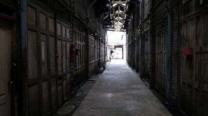 June 16 2021, Minburi, Thailand : Dark narrow alley an old town of Minburi old market, undeveloped area with old buildings.