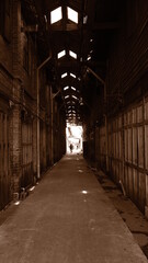 June 16 2021, Minburi, Thailand : Dark and sepia narrow alley an old town of Minburi old market, undeveloped area with old buildings.