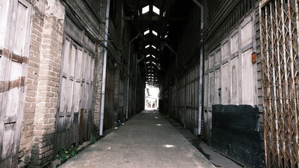 June 16 2021, Minburi, Thailand : Dark narrow alley an old town of Minburi old market, undeveloped area with old buildings.