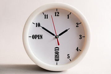 Sign design for a shop or office, opening and closing times in the form of a wall clock.
