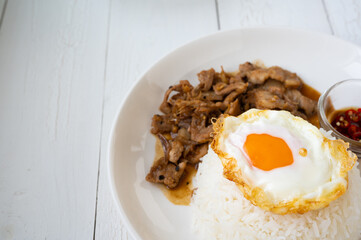 Fried Pork with Garlic, Pepper and fried egg on rice. Easy thai food.