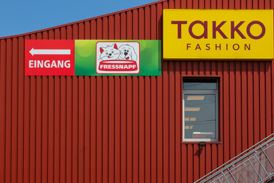 Neuwied, Germany - June 20, 2021:  a red facade with the brand of Takko. Takko is a German textile discounter chain.