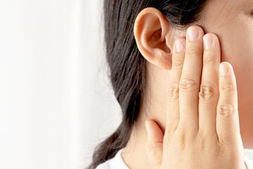 Young woman suffering from earache and tinnitus Causes of ear pain include otitis media and earwax...