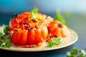 Delicious stuffed tomatoes in shape of pumpkin with rice, vegetables and meat. Concept homemade healthy eating.