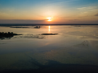 Obraz premium Sunrise over the wide river Dnieper. Aerial drone view.