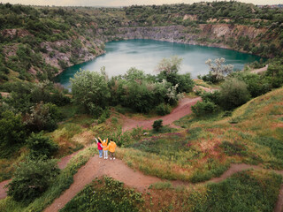 woman traveler hiker looking at blue lake