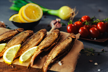 Fish. Smoked whitefish. Smoked fish on the table with toppings. Vegetables and fish.