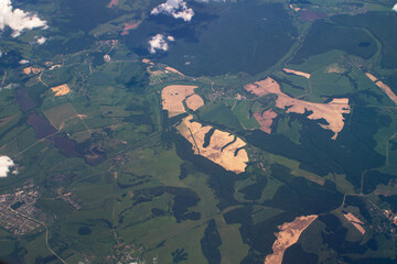 landscape under the wing of an airplane, bizarre outlines of fields and forests on the ground