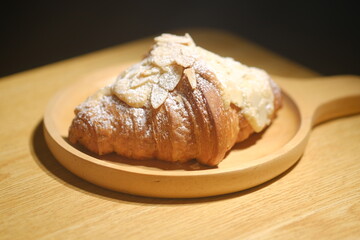 delicious croissant on a wood plate at the kitchen