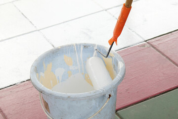 Paint roller in the bucket of paint