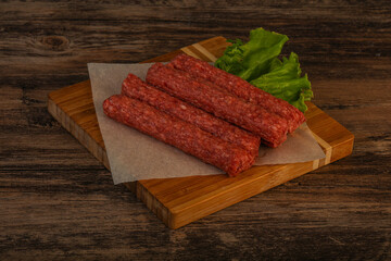 Raw beef sausages with spices