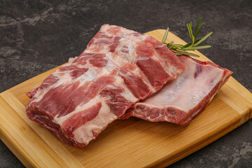 Raw pork ribs served rosemary
