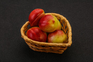 Sweet small nectarines in the basket