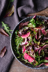 Bowl with couscous and vegetables on wooden background, closeup
