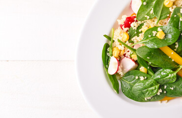 Plate with couscous and vegetables on white background