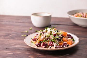 Plate with couscous and vegetables on wooden background