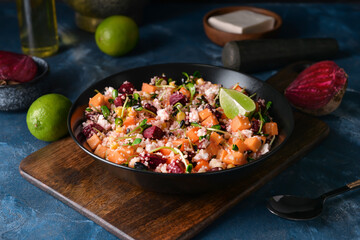 Bowl with couscous and vegetables on color background