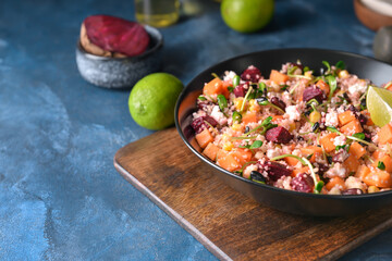 Bowl with couscous and vegetables on color background