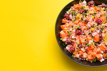 Bowl with couscous and vegetables on color background