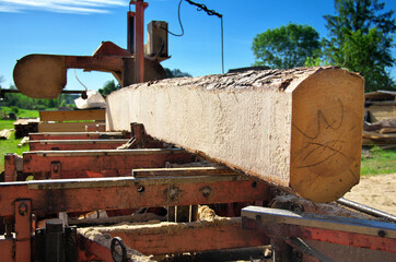 sawing logs on a mobile sawmill. log on the sawmill. preparation for cutting wood.