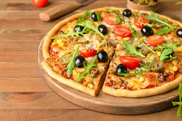 Board with tasty pizza on wooden background