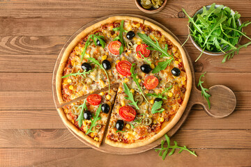 Board with tasty pizza on wooden background