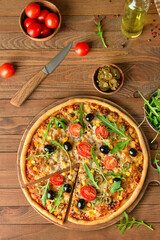 Board with tasty pizza on wooden background