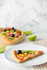 Plate with slice of tasty pizza on light background