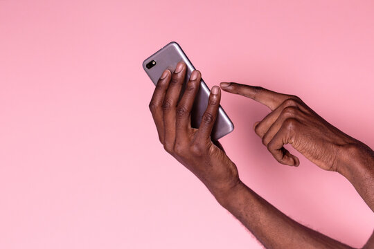 Hands of black man using phone