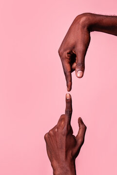 Opposed hands of black man pointing at each other