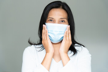 Woman under face mask covering mouth and nose.  Corona Virus or COVID-19 concept.