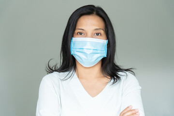 Woman under face mask covering mouth and nose.  Corona Virus or COVID-19 concept.