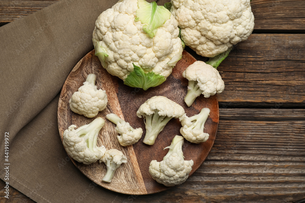 Wall mural plate with cauliflower cabbages on wooden background