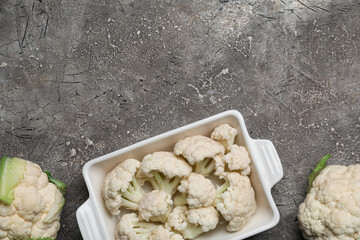 Baking dish with cauliflower cabbage on grunge background