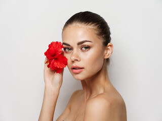 Fototapeta premium woman with bare shoulders red flower pure skin charm studio