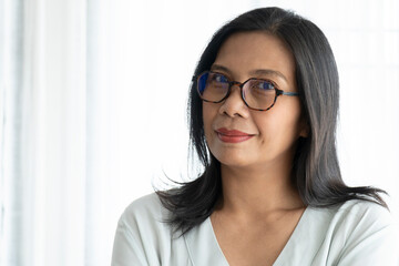 Smiling Woman Wearing Glasses with Black Long Hair.  Middle Age Lady Positive Thinking in Her Life Style.