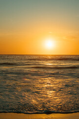 A sunrise over a beach.