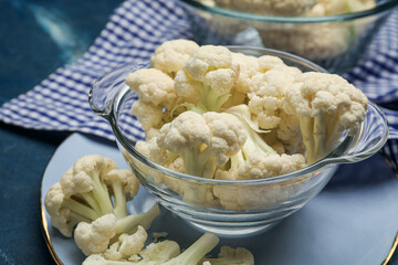 Bowl with cauliflower cabbage on color background, closeup